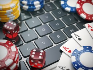 Casino,Online.,Gambling,Chips,,,Cards,And,Dice,On,Laptop